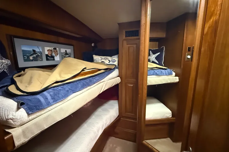 Slide: The Image of Cozy cabin interior of 1989 Viking 48 Convertible yacht with wooden bunk beds. - 28