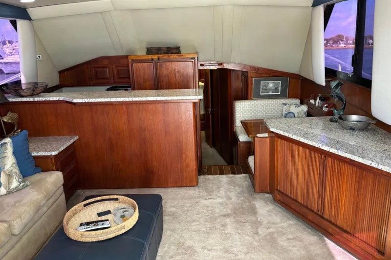 Slide: The Image of Luxurious interior of 1989 Viking 48 Convertible yacht with wood cabinetry and plush seating. - 15