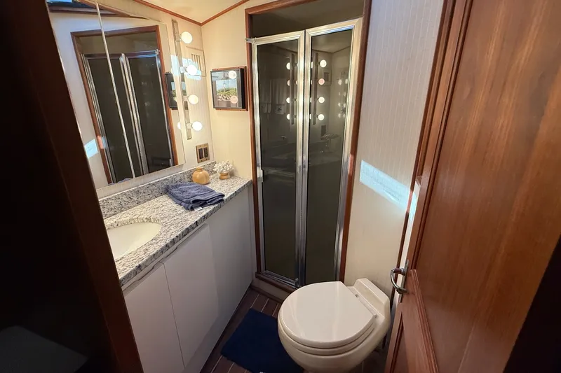 Slide: The Image of Bathroom interior of 1989 Viking 48 Convertible yacht with granite countertop and shower. - 33