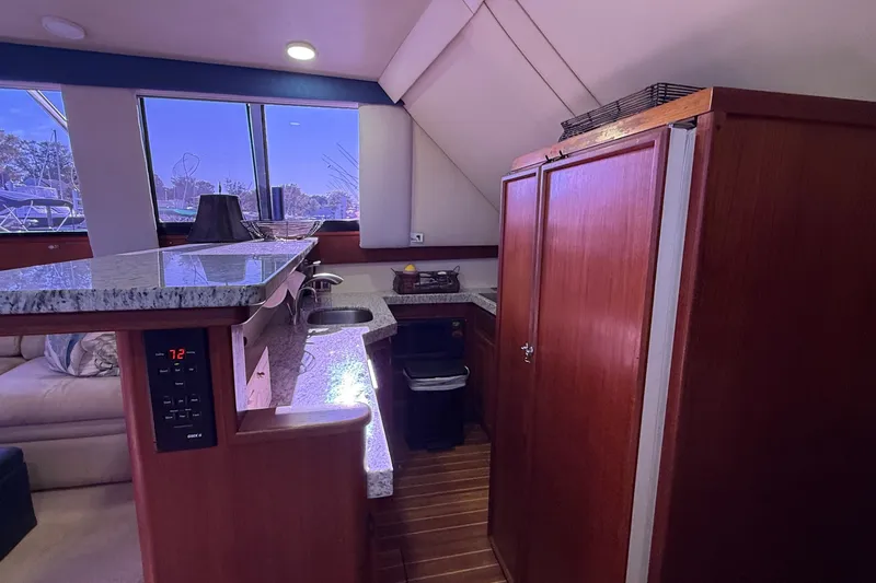 Slide: The Image of Interior of 1989 Viking 48 Convertible yacht with wooden cabinetry and granite countertops. - 20