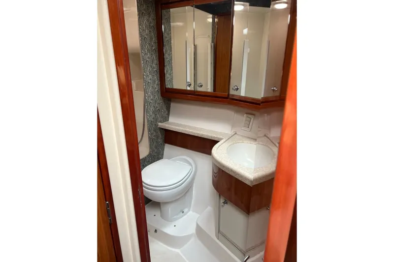 Slide: The Image of Bathroom interior of 1989 Viking 48 Convertible yacht with wood accents and modern fixtures. - 34