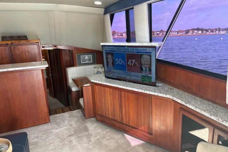 Slide: The Image of Interior of a 1989 Viking 48 Convertible yacht with a TV and scenic water view. - 16