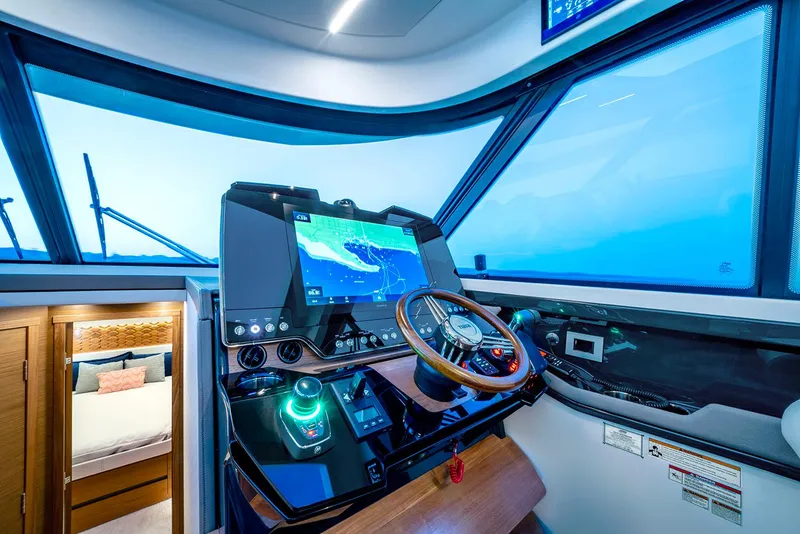 Slide: The Image of Manufacturer Provided Image: 2025 Tiara Yachts 48 LE helm with advanced navigation system and luxurious cabin view. - 13