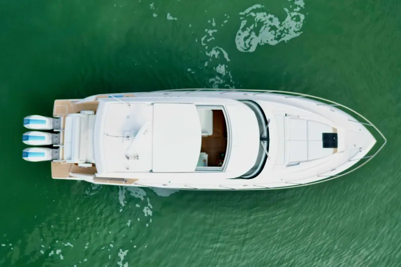 Slide: The Image of Aerial view of 2027 Tiara Yachts 48 LE on green water. - 40