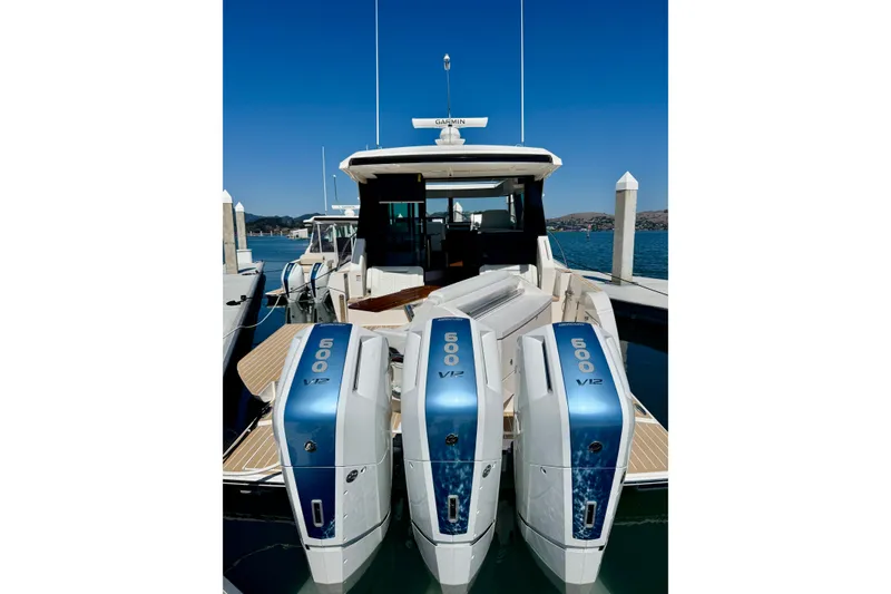 Slide: The Image of 2027 Tiara Yachts 48 LE with triple 600 V12 engines docked at marina. - 20