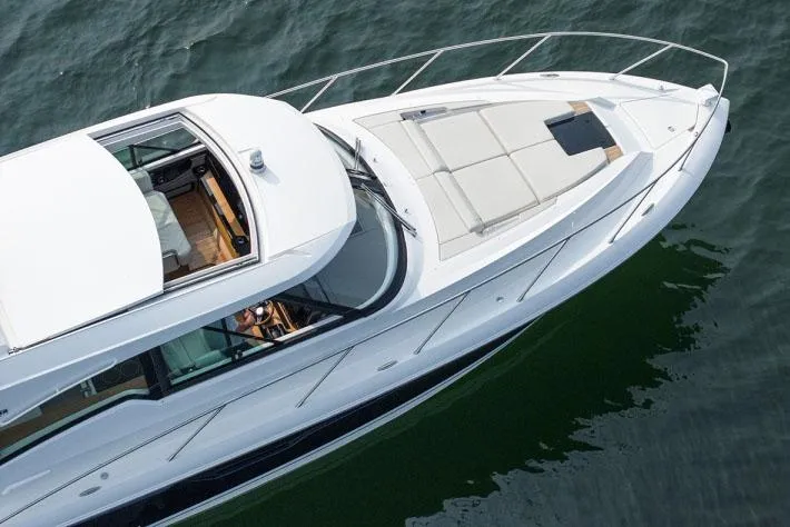 Slide: The Image of Manufacturer Provided Image: 2025 Tiara Yachts 48 LE luxury yacht cruising on water, top view. - 4