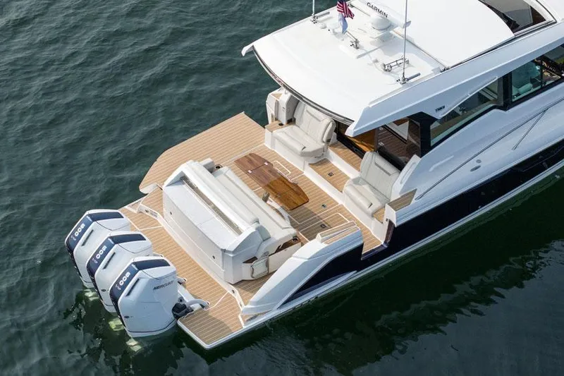 Slide: The Image of Manufacturer Provided Image: 2025 Tiara Yachts 48 LE luxury boat with triple outboard engines on water. - 7
