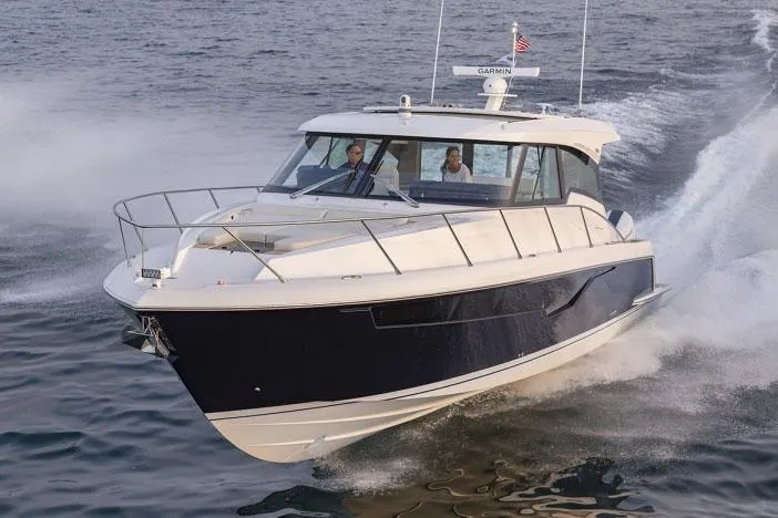 Slide: The Image of Manufacturer Provided Image: 2025 Tiara Yachts 48 LE cruising on open water, showcasing sleek design and performance. - 1