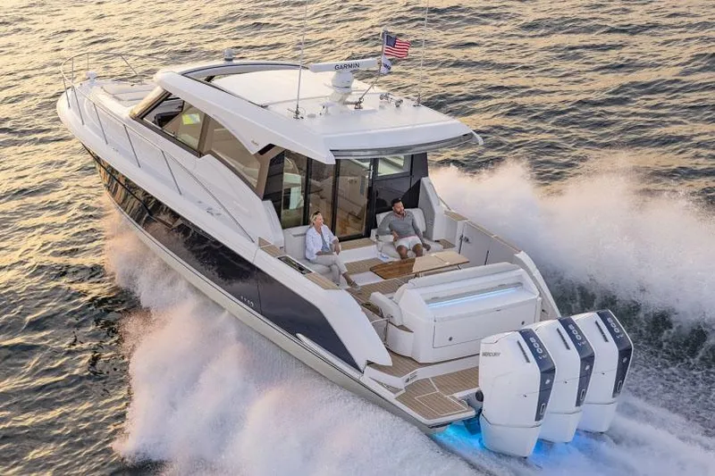 Slide: The Image of Manufacturer Provided Image: 2025 Tiara Yachts 48 LE cruising on water with passengers, showcasing luxury and performance. - 3
