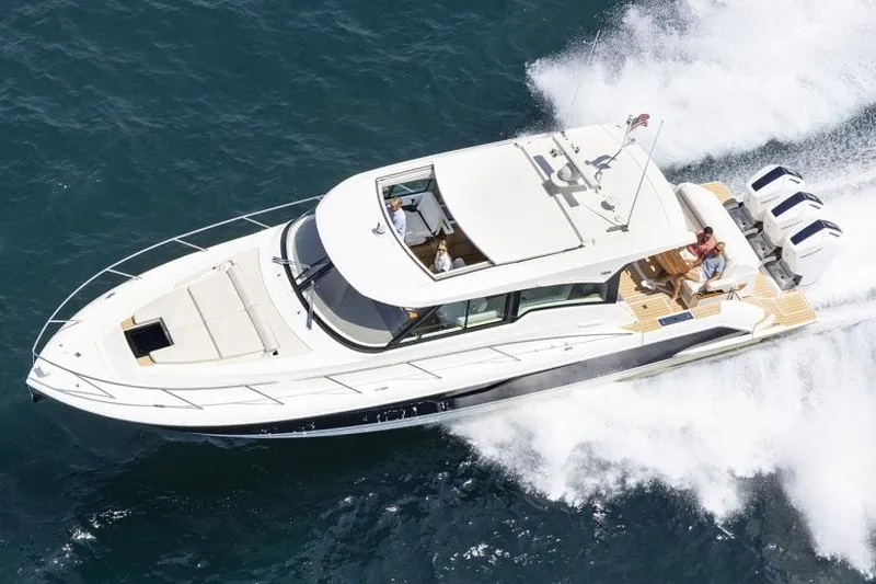 Slide: The Image of Manufacturer Provided Image: 2025 Tiara Yachts 48 LE cruising on open water, showcasing sleek design and powerful engines. - 2
