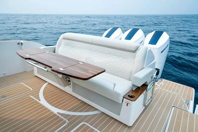 Slide: The Image of Manufacturer Provided Image: 2025 Tiara Yachts 48 LE luxury seating with wooden table on open sea. - 11