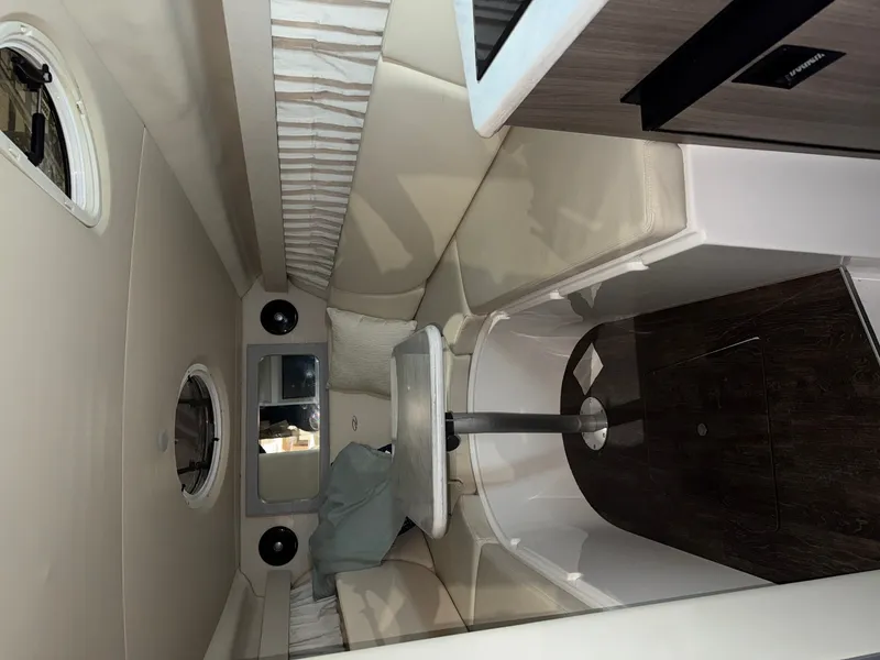 Slide: The Image of Interior of a 2019 Regal 28 Express with a stylish seating area and wood flooring. - 11