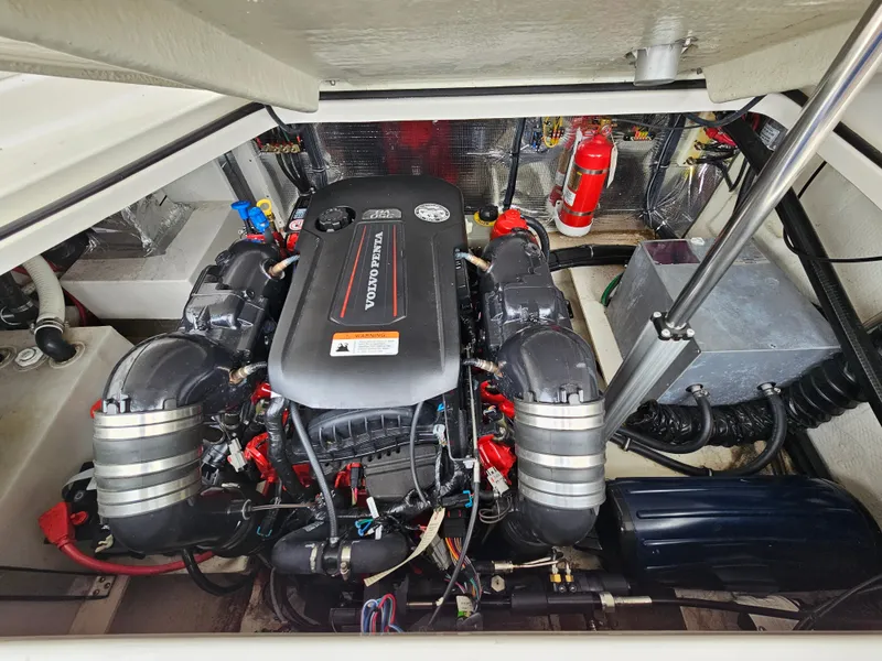 Slide: The Image of Engine compartment of a 2019 Regal 28 Express with a clean, well-organized engine and fire extinguisher. - 9