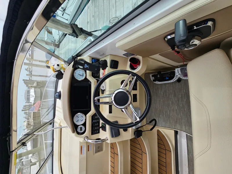 Slide: The Image of The cockpit of a 2019 Regal 28 Express with a sleek steering wheel and modern instruments. - 3