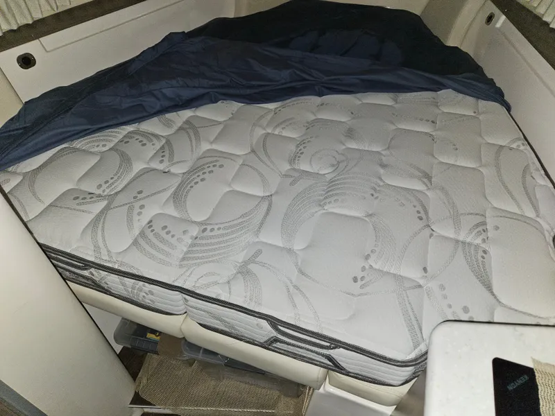 Slide: The Image of A cozy sleeping cabin with a padded mattress and blue bedding. - 13