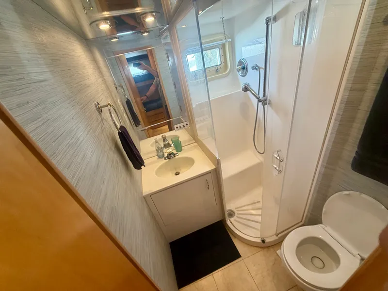 Slide: The Image of Bathroom with shower, sink, and toilet in a 1999 Hatteras 52 Cockpit Motor Yacht. - 27