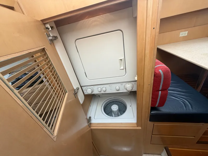 Slide: The Image of Washer and dryer in a wooden cabin with seating area and storage. - 30