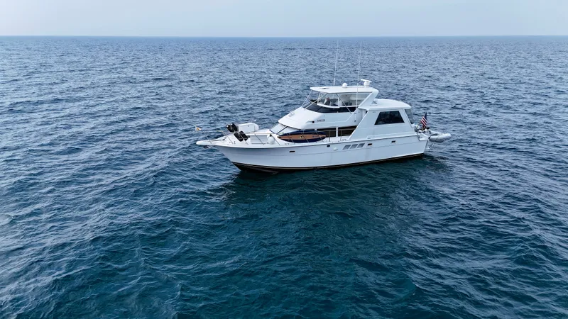 The Image of A 1999 Hatteras 52 Cockpit Motor Yacht on open water. - 4