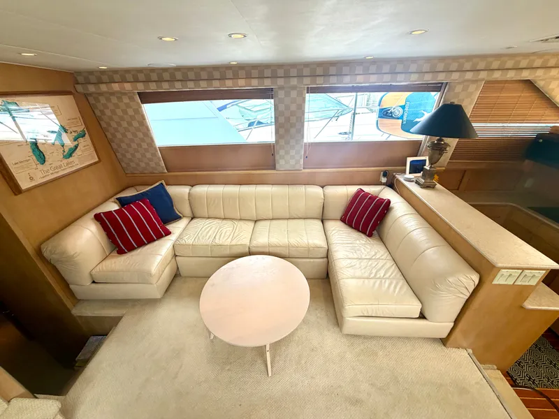 Slide: The Image of Interior of the 1999 Hatteras 52 Cockpit Motor Yacht with beige leather sofa and round table. - 20