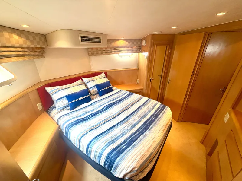 Slide: The Image of The image shows a cozy cabin with a double bed, wooden furnishings, and soft lighting. - 22