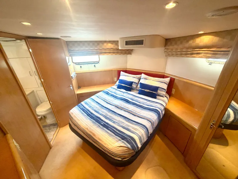 Slide: The Image of The image shows a cozy cabin with a double bed, wooden furnishings, and an adjoining bathroom. - 23