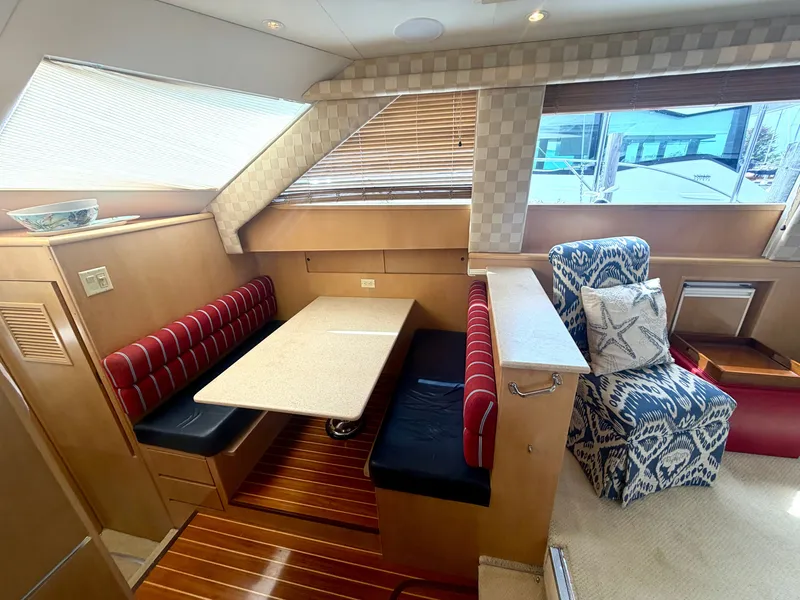 Slide: The Image of Interior of the 1999 Hatteras 52 Cockpit Motor Yacht with dining area and cozy seating. - 21