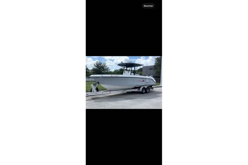 Slide: The Image of 2004 Donzi 29 ZF Open boat on trailer, parked outdoors. - 3