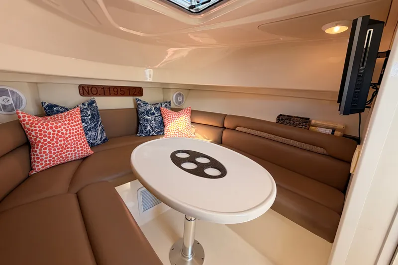 Slide: The Image of Interior of 2006 Boston Whaler 285 Conquest with cozy seating and decorative pillows. - 21