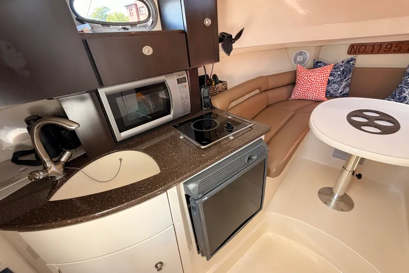 Slide: The Image of Interior of 2006 Boston Whaler 285 Conquest with kitchenette and seating area. - 19