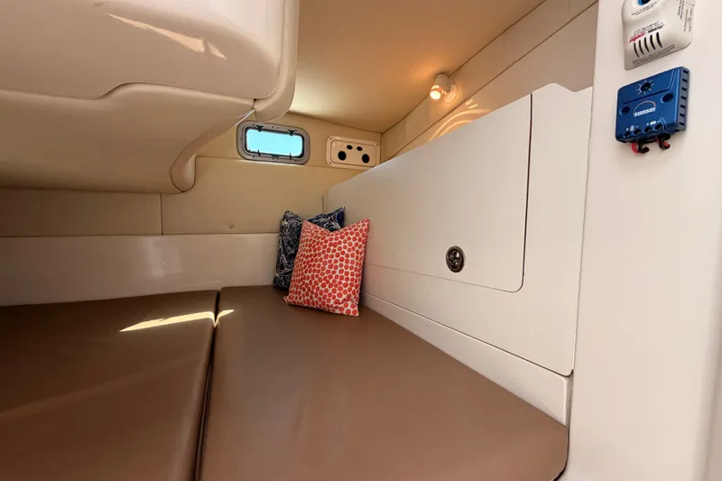 Slide: The Image of Interior cabin of 2006 Boston Whaler 285 Conquest with cushions and porthole. - 27