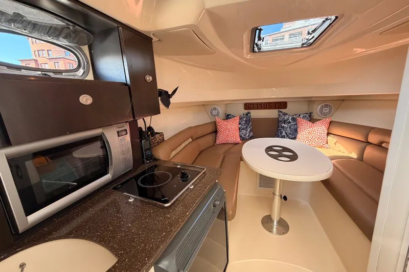 Slide: The Image of Interior of 2006 Boston Whaler 285 Conquest with kitchenette and cozy seating area. - 20