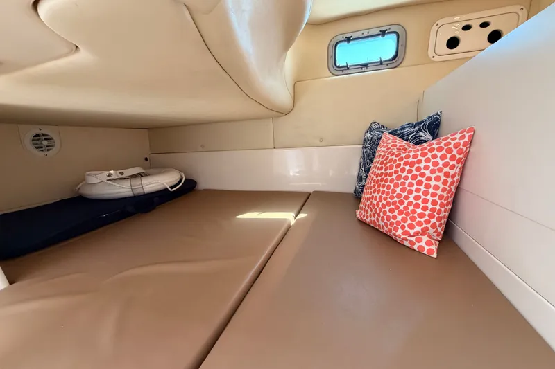 Slide: The Image of Interior cabin of 2006 Boston Whaler 285 Conquest with cushions and porthole. - 26