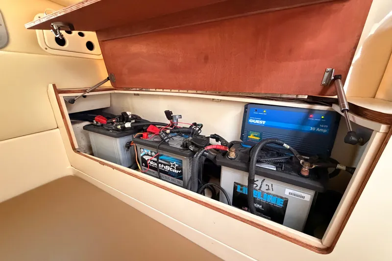 Slide: The Image of 2006 Boston Whaler 285 Conquest battery compartment with charger and NorthStar battery. - 30