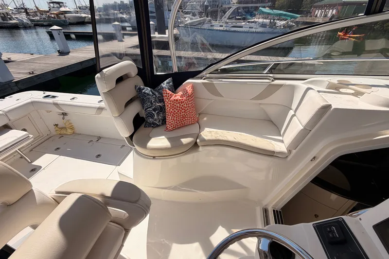 Slide: The Image of 2006 Boston Whaler 285 Conquest interior with seating and cushions, docked at marina. - 15