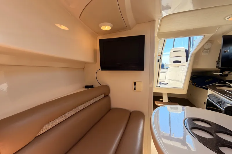 Slide: The Image of Interior of 2006 Boston Whaler 285 Conquest with seating, TV, and kitchenette. - 24