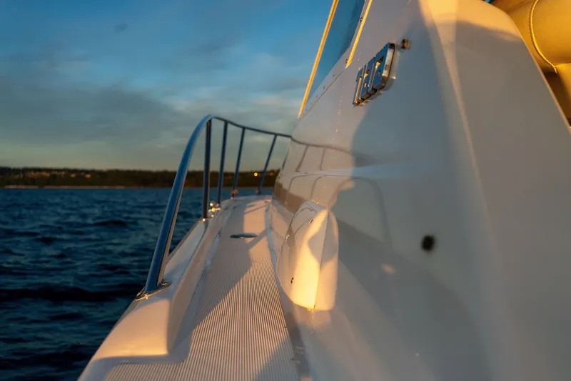 Slide: The Image of 2001 Tiara Yachts 3100 Open boat side view at sunset on the water. - 14