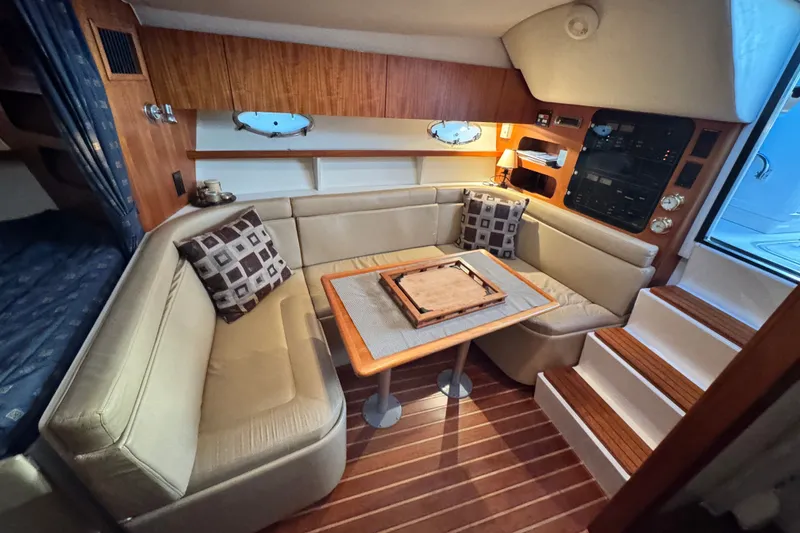 Slide: The Image of Luxurious interior of 2001 Tiara Yachts 3100 Open with cozy seating and elegant wood finishes. - 17