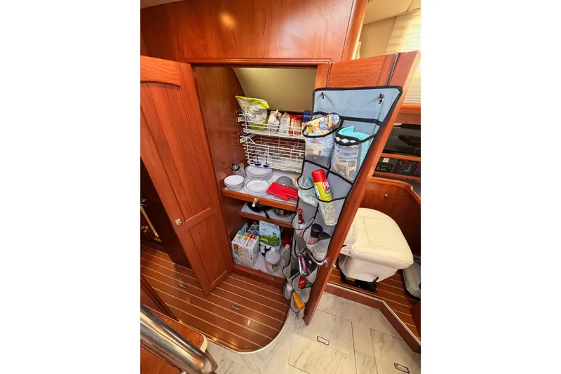 Slide: The Image of Interior storage of 2009 Hunter 50 Center Cockpit yacht with organized pantry shelves. - 77