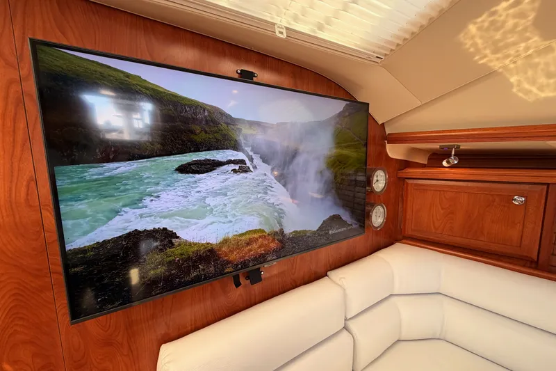 Slide: The Image of Luxurious 2009 Hunter 50 Center Cockpit interior with TV and elegant wood paneling. - 62