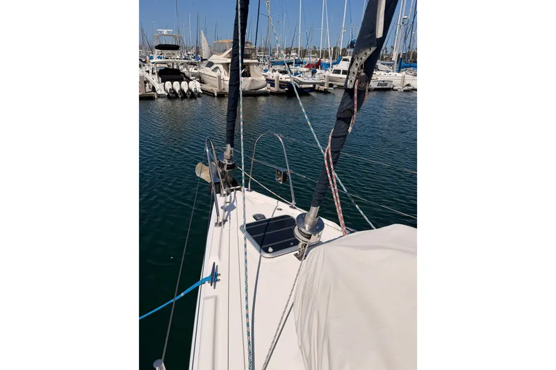 Slide: The Image of 2009 Hunter 50 Center Cockpit sailboat docked in a marina, surrounded by other boats. - 21
