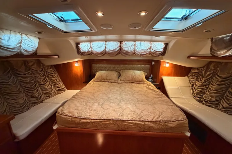 Slide: The Image of Luxurious 2009 Hunter 50 Center Cockpit bedroom with elegant bedding and ambient lighting. - 84