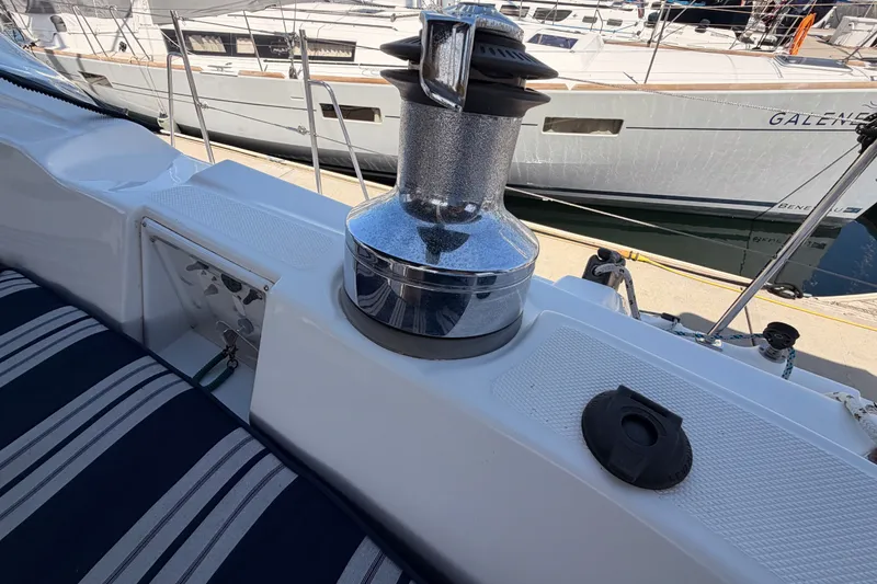 Slide: The Image of 2009 Hunter 50 Center Cockpit sailboat deck with winch and striped seating. - 34