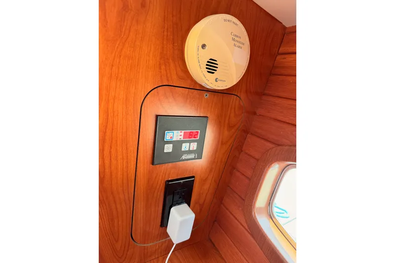 Slide: The Image of Interior of 2009 Hunter 50 Center Cockpit with carbon monoxide alarm and control panel. - 114