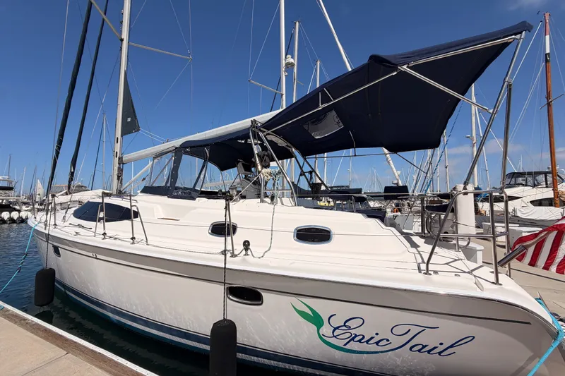 Slide: The Image of 2009 Hunter 50 Center Cockpit sailboat docked at marina under clear blue sky. - 8