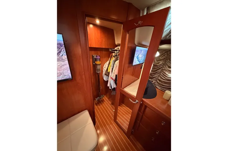 Slide: The Image of Interior of 2009 Hunter 50 Center Cockpit yacht with wooden cabinetry and closet. - 93