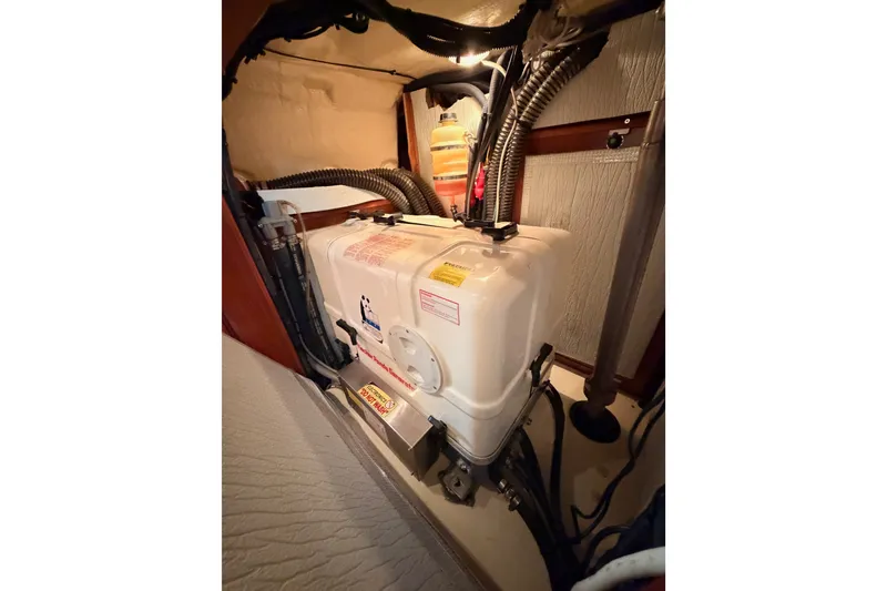 Slide: The Image of Engine compartment of a 2009 Hunter 50 Center Cockpit sailboat, showing mechanical components. - 107