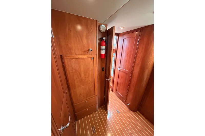Slide: The Image of Interior of 2009 Hunter 50 Center Cockpit with wooden cabinetry and flooring. - 72