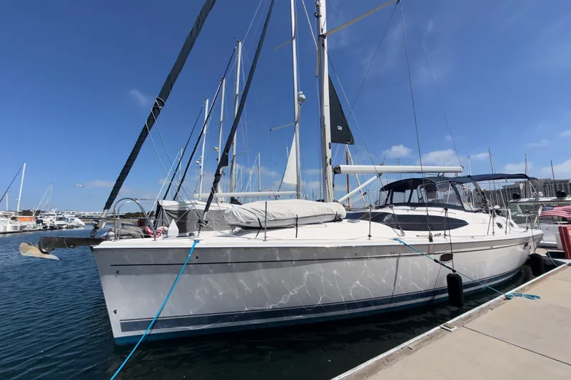 Slide: The Image of 2009 Hunter 50 Center Cockpit sailboat docked at marina under clear blue sky. - 3
