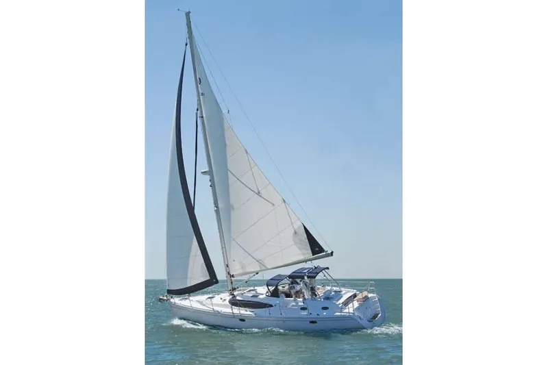 Slide: The Image of 2009 Hunter 50 Center Cockpit sailboat navigating on open water under clear skies. - 2