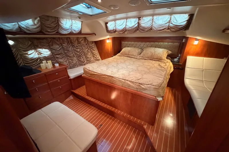 Slide: The Image of Luxurious 2009 Hunter 50 Center Cockpit bedroom with elegant wood finish and plush bedding. - 83